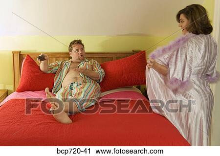 Woman opening robe to husband View Large Photo Image Stock Image - Woman opening robe to husband. Fotosearch