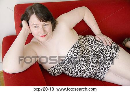 Woman posing on sofa View Large Photo Image Stock Photo - Woman posing on sofa. Fotosearch
