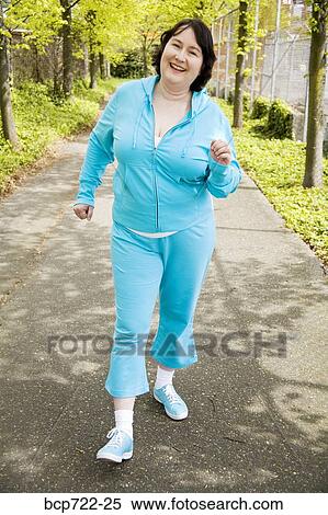 Woman power walking outdoors View Large Photo Image Stock Photography - Woman power walking outdoors. Fotosearch