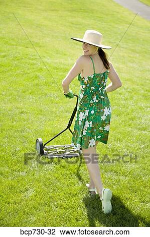 Woman pushing lawn mower View Large Photo Image Stock Image - Woman pushing lawn mower. Fotosearch