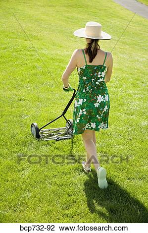Woman pushing lawn mower View Large Photo Image Stock Image - Woman pushing lawn mower. Fotosearch