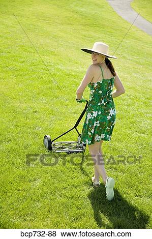 Woman pushing lawn mower View Large Photo Image Stock Photo - Woman pushing lawn mower. Fotosearch