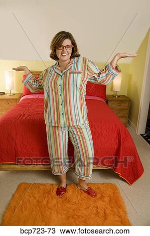 Woman showing off pajamas in bedroom View Large Photo Image Stock Image - Woman showing off pajamas in bedroom. Fotosearch