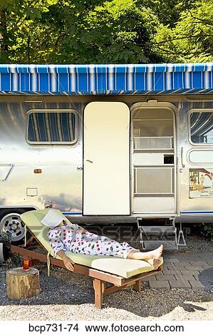 Woman sleeping in front of motor home View Large Photo Image Picture - Woman sleeping in front of motor home. Fotosearch