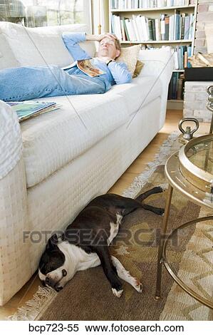 Stock Photography - Woman sleeping on sofa. Fotosearch