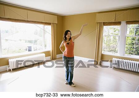 Woman standing in new house View Large Photo Image Stock Image - Woman standing in new house. Fotosearch