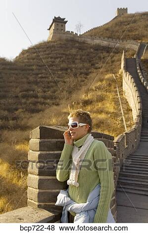 Woman talking on her cell phone, The Great Wall, China View Large Photo Image Stock Photo - Woman talking on her cell phone, The Great Wall, China. Fotosearch