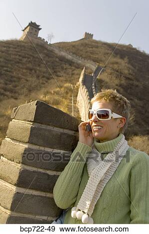 Woman talking on her cell phone, The Great Wall, China View Large Photo Image Stock Photo - Woman talking on her cell phone, The Great Wall, China. Fotosearch