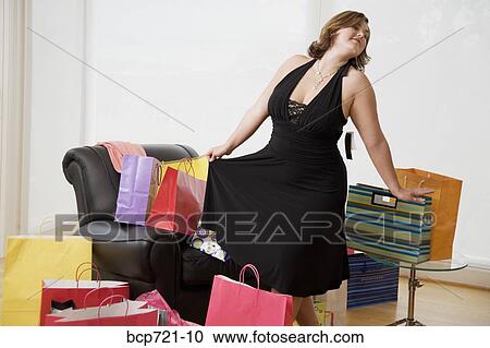 Woman trying on new dress View Large Photo Image Stock Image - Woman trying on new dress. Fotosearch