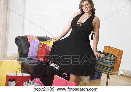 Woman trying on new dress View Large Photo Image Stock Photo - Woman trying on new dress. Fotosearch