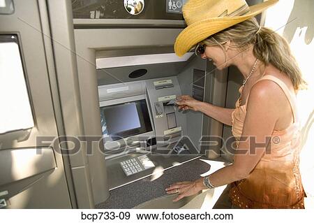 Woman using automatic teller machine View Large Photo Image Stock Photo - Woman using automatic teller machine. Fotosearch