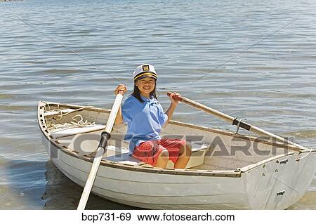 Stock Photo - Young Asian girl in row boat. Fotosearch