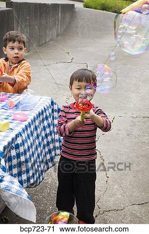 Young boy blowing bubbles View Large Photo Image Stock Image - Young boy blowing bubbles. Fotosearch
