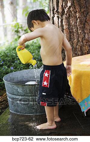 Young boy playing with water View Large Photo Image Stock Image - Young boy playing with water. Fotosearch