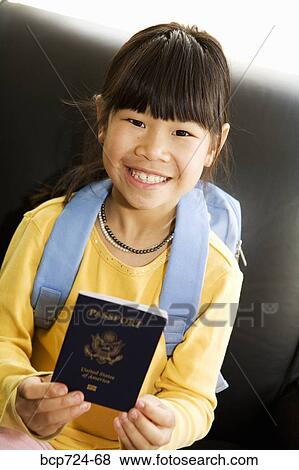 Stock Photo - Young girl holding passport. Fotosearch