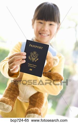 Young girl holding teddy bear and passport View Large Photo Image Stock Photography - Young girl holding teddy bear and passport. Fotosearch
