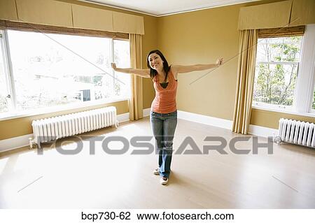 Stock Image - Young woman in new house. Fotosearch