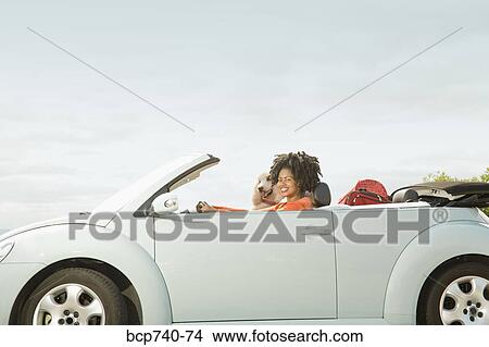 African woman and dog in convertible car View Large Photo Image Picture - African woman and dog in convertible car. Fotosearch
