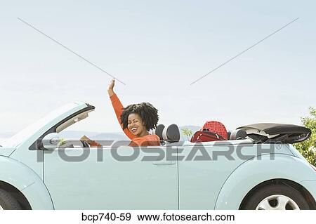 African woman driving convertible car View Large Photo Image Stock Photo - African woman driving convertible car. Fotosearch