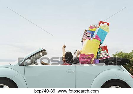 African woman in convertible with shopping bags View Large Photo Image Stock Photo - African woman in convertible with shopping bags. Fotosearch