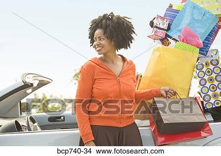 African woman next to car filled with shopping bags View Large Photo Image Picture - African woman next to car filled with shopping bags. Fotosearch