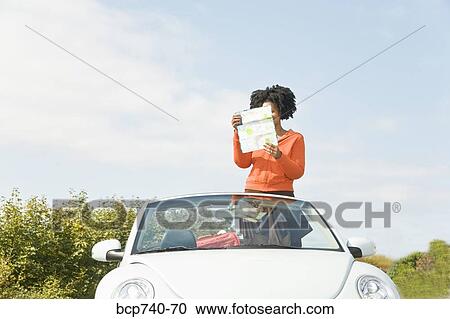 African woman reading map in convertible car View Large Photo Image Stock Image - African woman reading map in convertible car. Fotosearch