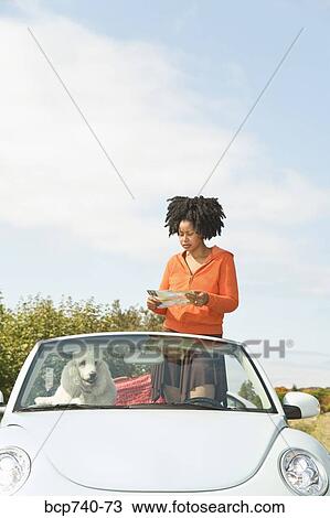 African woman reading map in convertible car View Large Photo Image Stock Image - African woman reading map in convertible car. Fotosearch