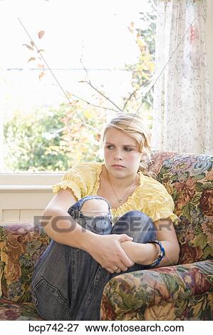 Angry teenaged girl sitting in chair View Large Photo Image Stock Photo - Angry teenaged girl sitting in chair. Fotosearch