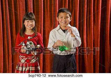 Asian boy and girl holding science experiments View Large Photo Image Stock Image - Asian boy and girl holding science experiments. Fotosearch