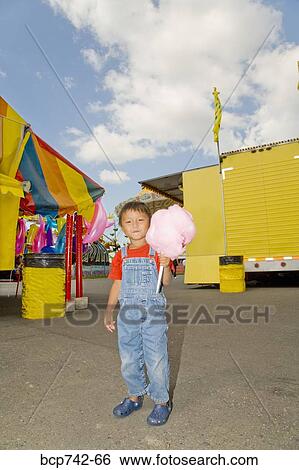 Asian boy holding cotton candy View Large Photo Image Stock Photograph - Asian boy holding cotton candy. Fotosearch