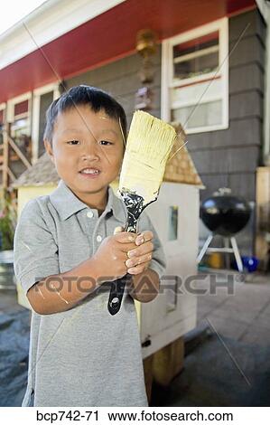 Asian boy holding paintbrush View Large Photo Image Stock Image - Asian boy holding paintbrush. Fotosearch