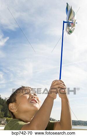 Asian boy holding pinwheel View Large Photo Image Stock Image - Asian boy holding pinwheel. Fotosearch