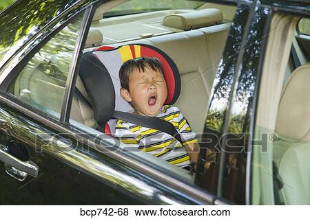 Asian boy yawning in car seat View Large Photo Image Stock Photo - Asian boy yawning in car seat. Fotosearch