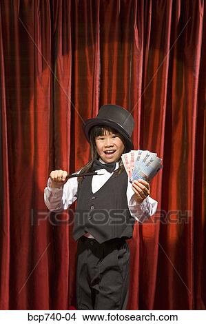 Asian girl performing magic trick on stage View Large Photo Image Picture - Asian girl performing magic trick on stage. Fotosearch
