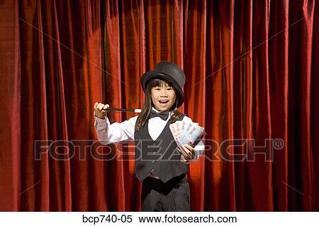 Asian girl performing magic trick on stage View Large Photo Image Stock Photography - Asian girl performing magic trick on stage. Fotosearch