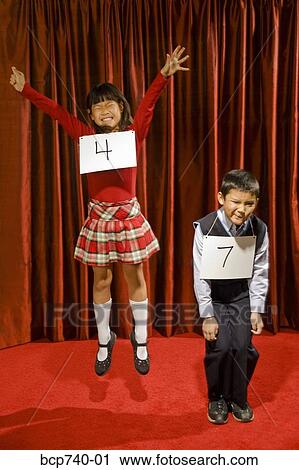 Asian girl wearing number and cheering on stage View Large Photo Image Stock Image - Asian girl wearing number and cheering on stage. Fotosearch