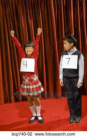 Asian girl wearing number and cheering on stage View Large Photo Image Stock Image - Asian girl wearing number and cheering on stage. Fotosearch