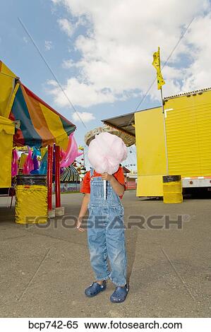 Boy holding cotton candy in front of face View Large Photo Image Stock Photography - Boy holding cotton candy in front of face. Fotosearch