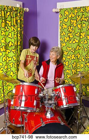 Boy showing grandmother how to play drums View Large Photo Image Stock Photo - Boy showing grandmother how to play drums. Fotosearch