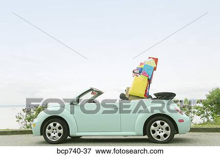 Convertible car with shopping bags in backseat View Large Photo Image Stock Photo - Convertible car with shopping bags in backseat. Fotosearch