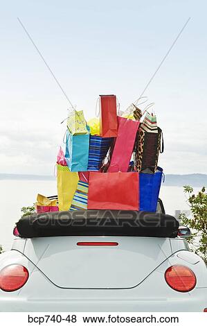 Convertible car with shopping bags in backseat View Large Photo Image Stock Photo - Convertible car with shopping bags in backseat. Fotosearch