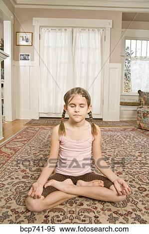 Girl meditating on floor View Large Photo Image Stock Photography - Girl meditating on floor. Fotosearch