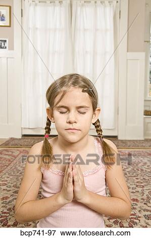 Girl praying with eyes closed View Large Photo Image Stock Photo - Girl praying with eyes closed. Fotosearch