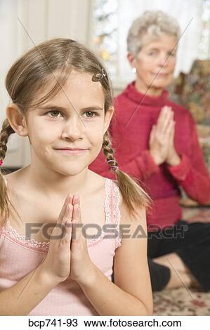 Grandmother and granddaughter practicing yoga View Large Photo Image Stock Image - Grandmother and granddaughter practicing yoga. Fotosearch