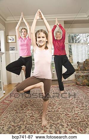 Grandmother, mother and daughter practicing yoga View Large Photo Image Stock Photo - Grandmother, mother and daughter practicing yoga. Fotosearch