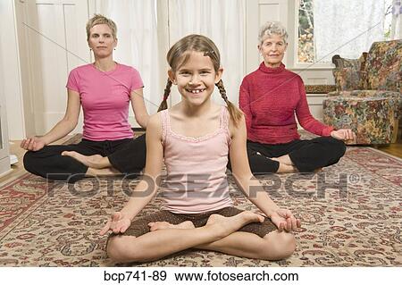 Stock Photo - Grandmother, mother and daughter practicing yoga. Fotosearch