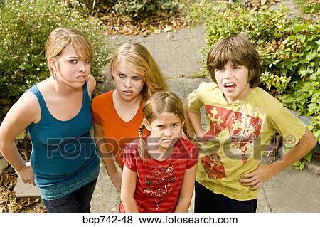 Group of siblings making faces View Large Photo Image Stock Photo - Group of siblings making faces. Fotosearch
