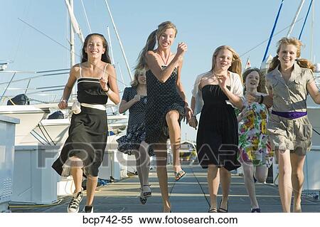 Group of teenaged girls running at marina View Large Photo Image Stock Photography - Group of teenaged girls running at marina. Fotosearch