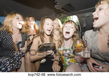 Stock Photo - Group of teenaged girls singing in limousine. Fotosearch
