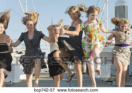 Group of teenaged girls skipping at marina View Large Photo Image Stock Photo - Group of teenaged girls skipping at marina. Fotosearch